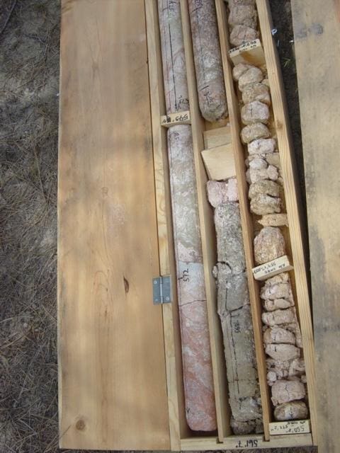 Rock core samples in a wooden box.