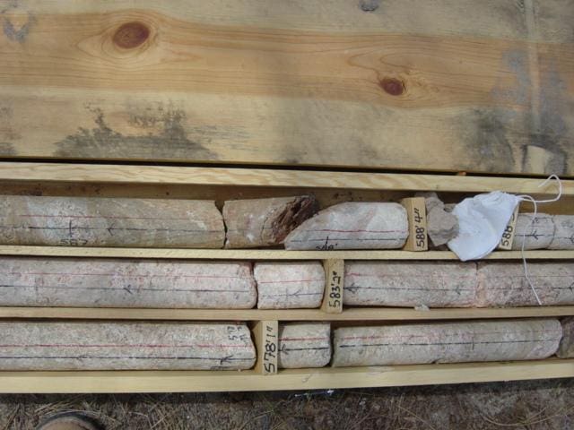 Rock core samples in wooden box.