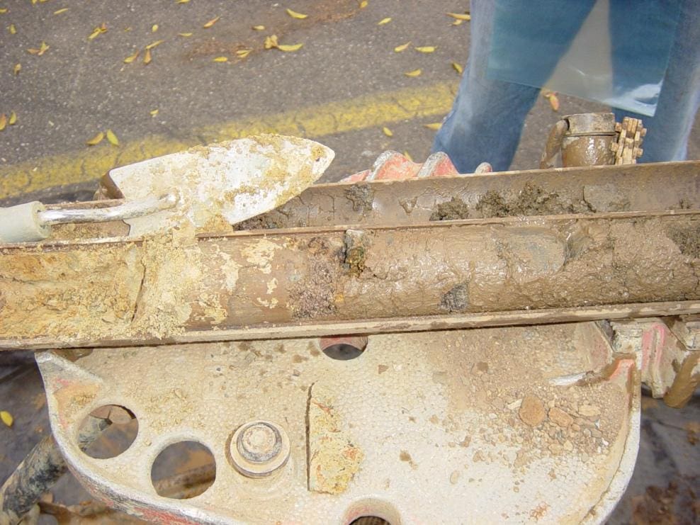 Soil sample in a metal core tube.